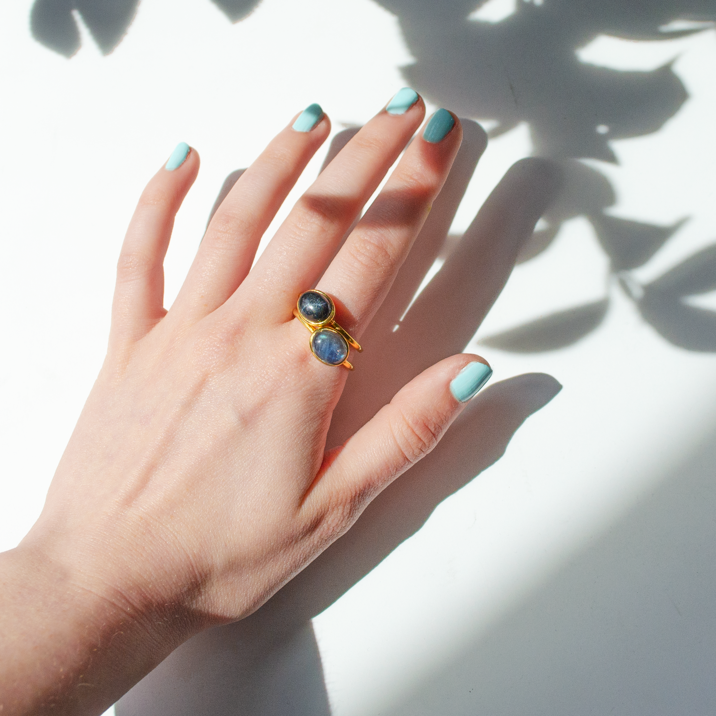 Model with Blue Manicure wears a vermeil gold plated sterling silver oval solitaire ring bezel set with Blue Labradorite, Black Star Sapphire and Blue Sunstone. Purple Turquoise Ring, Gold Turquoise Ring, Turquoise Stacking Ring, Turquoise Statement Ring