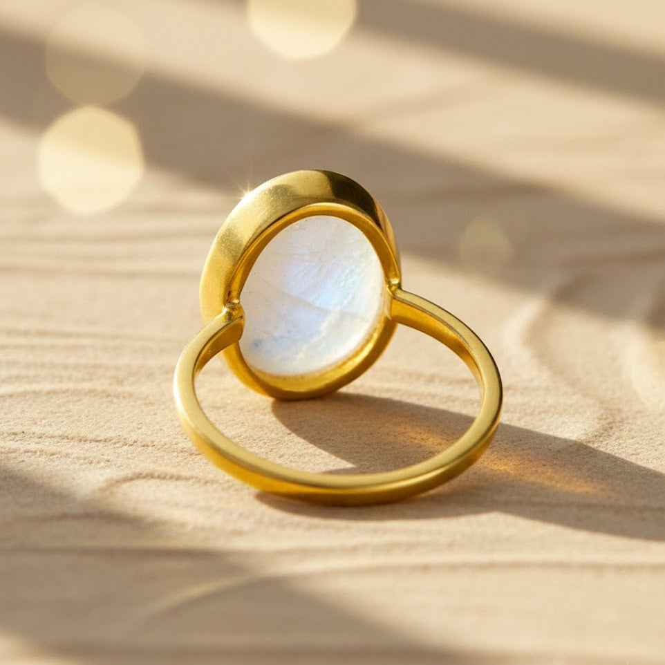 Gold vermeil rainbow moonstone oval ring shown from a side angle, highlighting the smooth bezel setting and elegant band design. June birthstone ring with a glowing oval moonstone, crafted in a minimalist silhouette ideal for stacking or wearing alone. Handmade moonstone jewelry perfect for birthdays, anniversaries, Valentine’s Day, or everyday elegance.