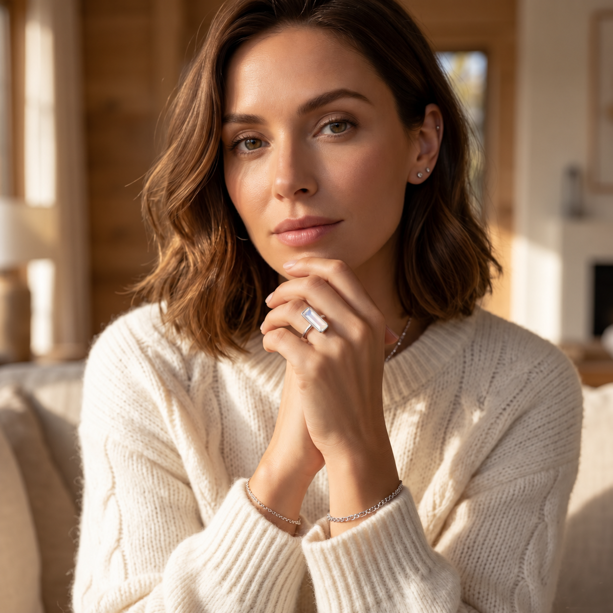 Woman wearing a large Opalite baguette ring in yellow gold as a modern geometric gemstone ring.
