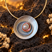 Ocean Breeze Sculptural Halo pendant necklace with blue and warm metallic abstract design on dark stone

