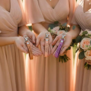 Bridesmaids holding matching personalized leather keychains, custom engraved leather key fob gifts for bridal party, wedding favors, and meaningful thank you gifts