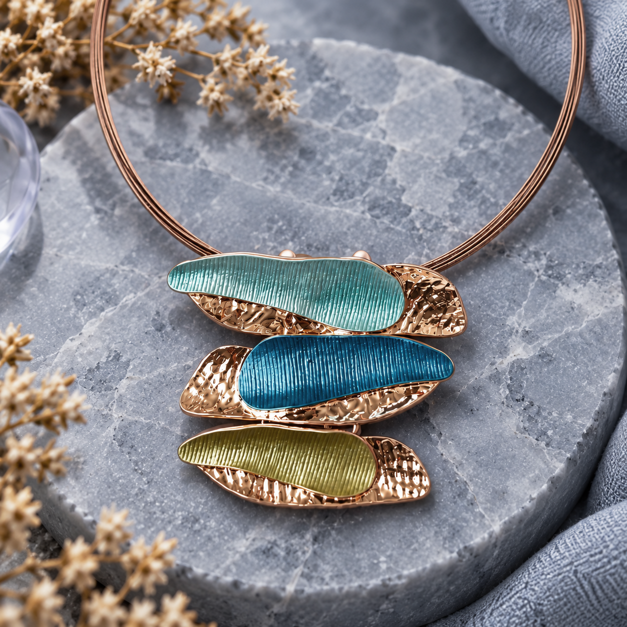  Aqua blue and olive triple barrette statement necklace displayed on gray stone
