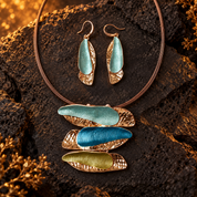 Blue and pink Triple Barrette earrings with matching colorful statement necklace on light background

