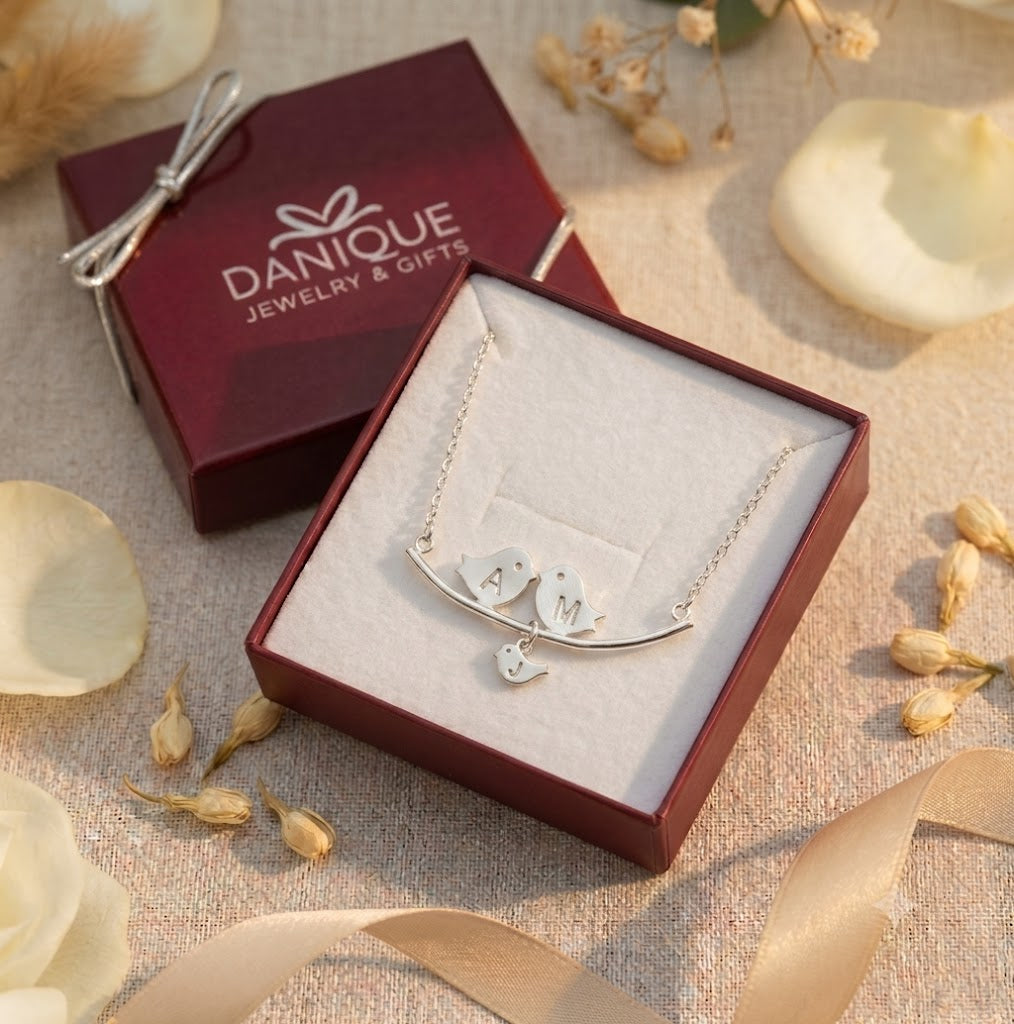 Silver personalized lovebirds necklace presented in a burgundy Danique Jewelry gift box.