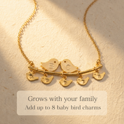 Gold lovebirds necklace with multiple initial baby bird charms designed to grow with a family.