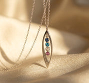 Dainty marquise necklace worn on neckline, minimalist birthstone pendant for layering and everyday styling in sterling silver