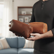 Professional man holding personalized leather toiletry bag with engraved monogram, luxury dopp kit for business or travel.