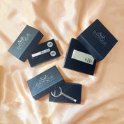 Gift-ready men’s accessories set on champagne satin: stainless steel tie slide, round initial cuff links, monogram money clip, and etched bar keychain, each in branded presentation boxes. Perfect for usher gifts, ring bearer thank-you, Father’s Day, retirement, corporate/executive gifts, birthday for husband, or Valentine’s gift for him. Custom initials with laser etching create a bespoke keepsake in a sleek, modern silver-tone style.
