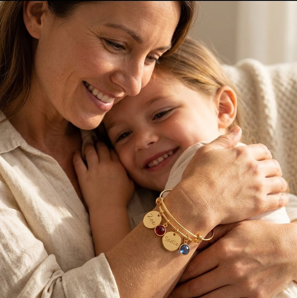 custom engraved bangle bracelet with name charms and birthstones, personalized jewelry on mom hugging her child