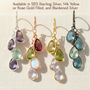 Set of four pairs of teardrop-shaped gemstone earrings in various metals on a light background.Custom birthstone earrings for grandma with hand-set teardrop gemstones arranged in a delicate drop style, representing grandchildren in a timeless and elegant design handcrafted in Massachusetts.