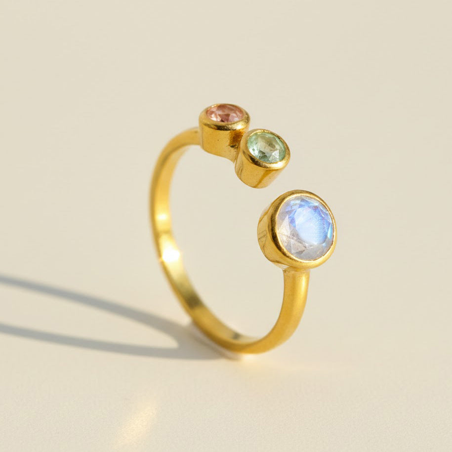 Adjustable gold birthstone ring for mom featuring customizable stones for each child, minimalist open band design with January garnet, February amethyst, and March aquamarine, a personalized mother’s ring perfect for Mother’s Day gift or family jewelry keepsake.
