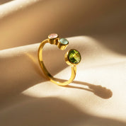 Elegant multi birthstone adjustable ring for mom of two displayed on soft satin, featuring one large mother birthstone and two small bezel-set child gemstones in a minimalist open band design. Crafted in gold vermeil, this dainty personalized family ring makes a sentimental gift for mom, ideal for Mother’s Day, birthdays, Christmas, or honoring her two children with meaningful customizable birthstones she can cherish daily.