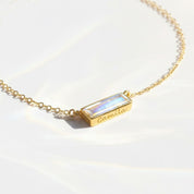 Moonstone bar necklace featuring a dainty bezel-set gemstone in 14k gold filled chain, personalized with custom engraving for a meaningful birthstone bar pendant. This minimalist gemstone bar necklace is perfect as a birthday gift, Mother’s Day jewelry, bridesmaid gift, or everyday necklace for her. Handcrafted in sterling silver, gold, or rose gold filled with elegant Adira design and customizable name or date engraving.
