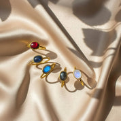 Minimalist oval rainbow moonstone, labradorite, garnet, sunstone rings in gold vermeil, designed as a June birthday gift for her.