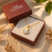 Personalized rainbow moonstone necklace displayed in Danique Jewelry gift box with warm sunlight and gift-ready packaging.