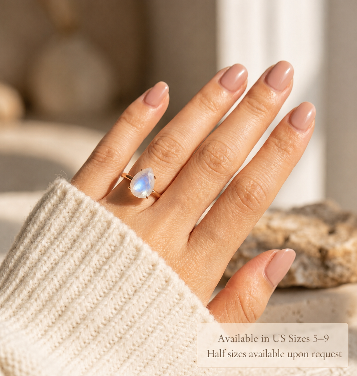 Moonstone ring and matching moonstone stud earrings worn by model in warm sunlight