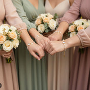 Bridesmaid gift set featuring custom initial and birthstone bracelets in gold, personalized wedding jewelry for bridal party with gemstones including amethyst, peridot, topaz, and garnet charms.