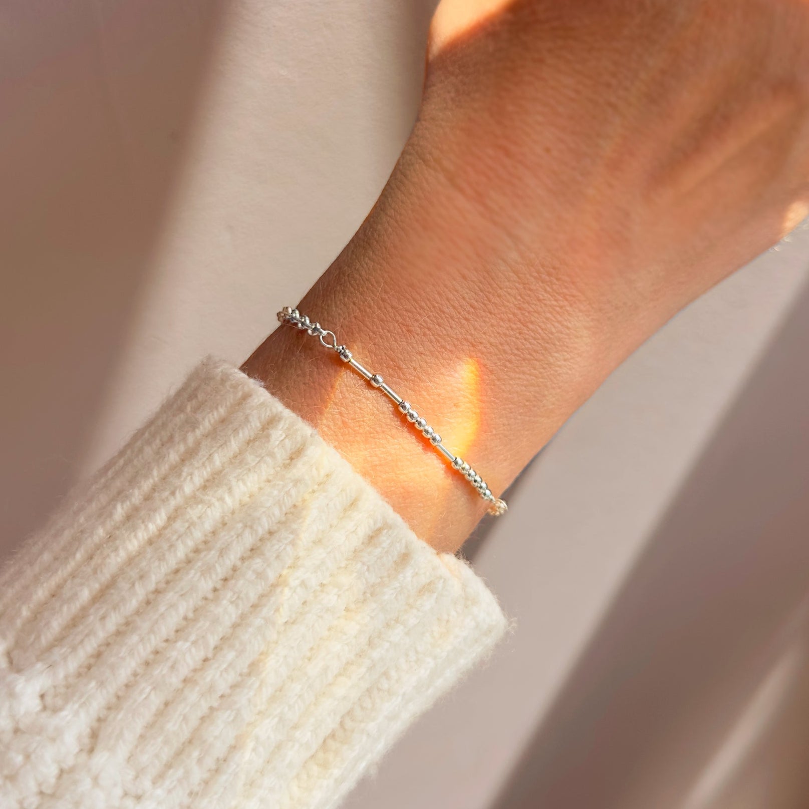 morse-code-bracelet-on-hand-sterling-silver.jpg