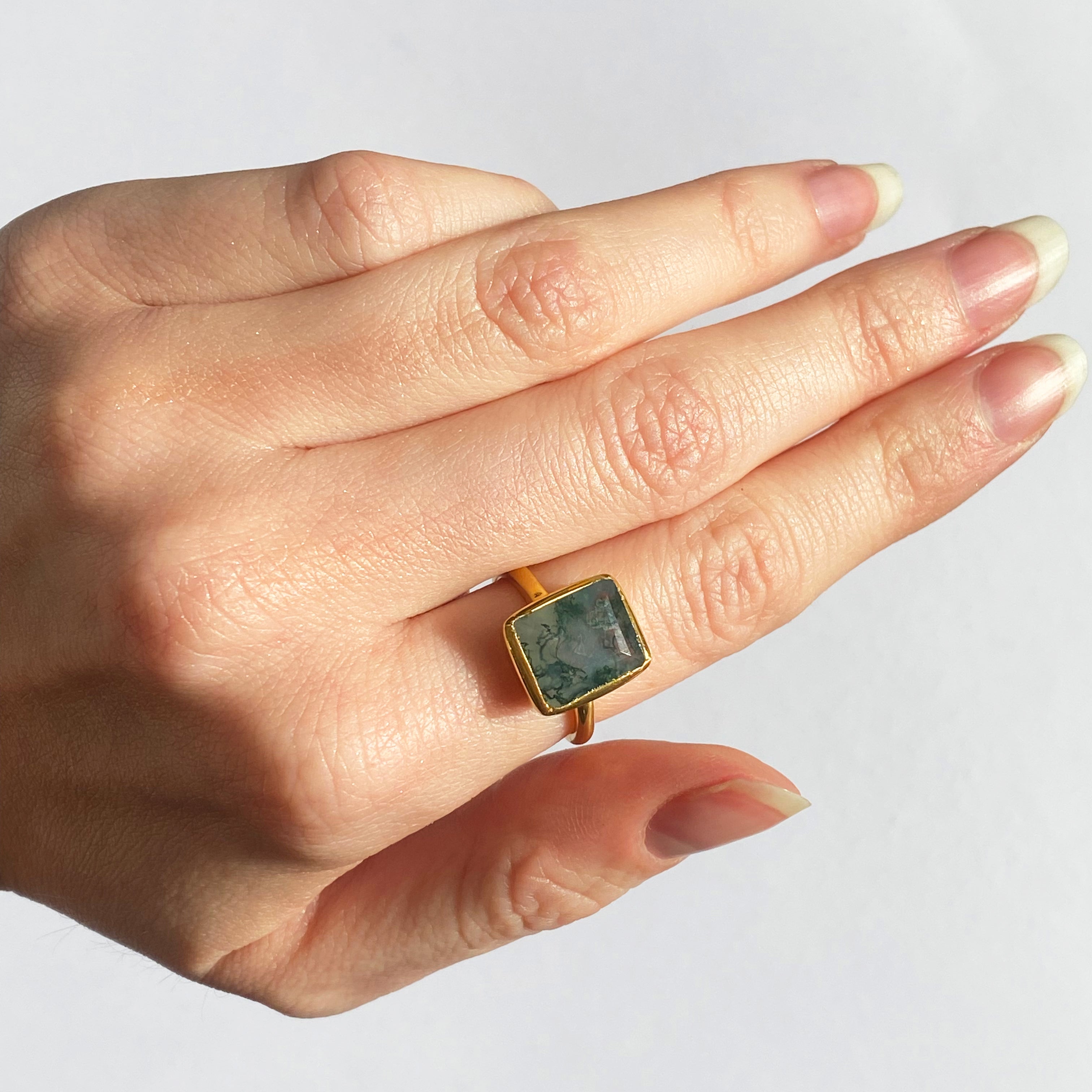 Large Rectangle Moss Agate Solitaire Ring in 18k Vermeil Gold is worn on the index finger of a model. Natural Moss Green Rectangle Ring, Statement Ring, Moss Agate Ring for Her, Birthday gift, Nature Lover gift