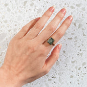 Large Rectangle Moss Agate Solitaire Ring in 18k Vermeil Gold is worn on the index finger of a model. Natural Moss Green Rectangle Ring, Statement Ring, Moss Agate Ring for Her, Birthday gift, Nature Lover gift