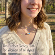 Horizontal gemstone bar necklaces shown in multiple birthstone colors for every month shown on a woman in beige sweater