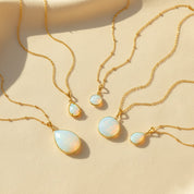 Opalite teardrop and round pendant necklaces on gold chains, iridescent milky white blue glow stones in multiple sizes, dainty minimalist layering jewelry, bridal something-blue gift.