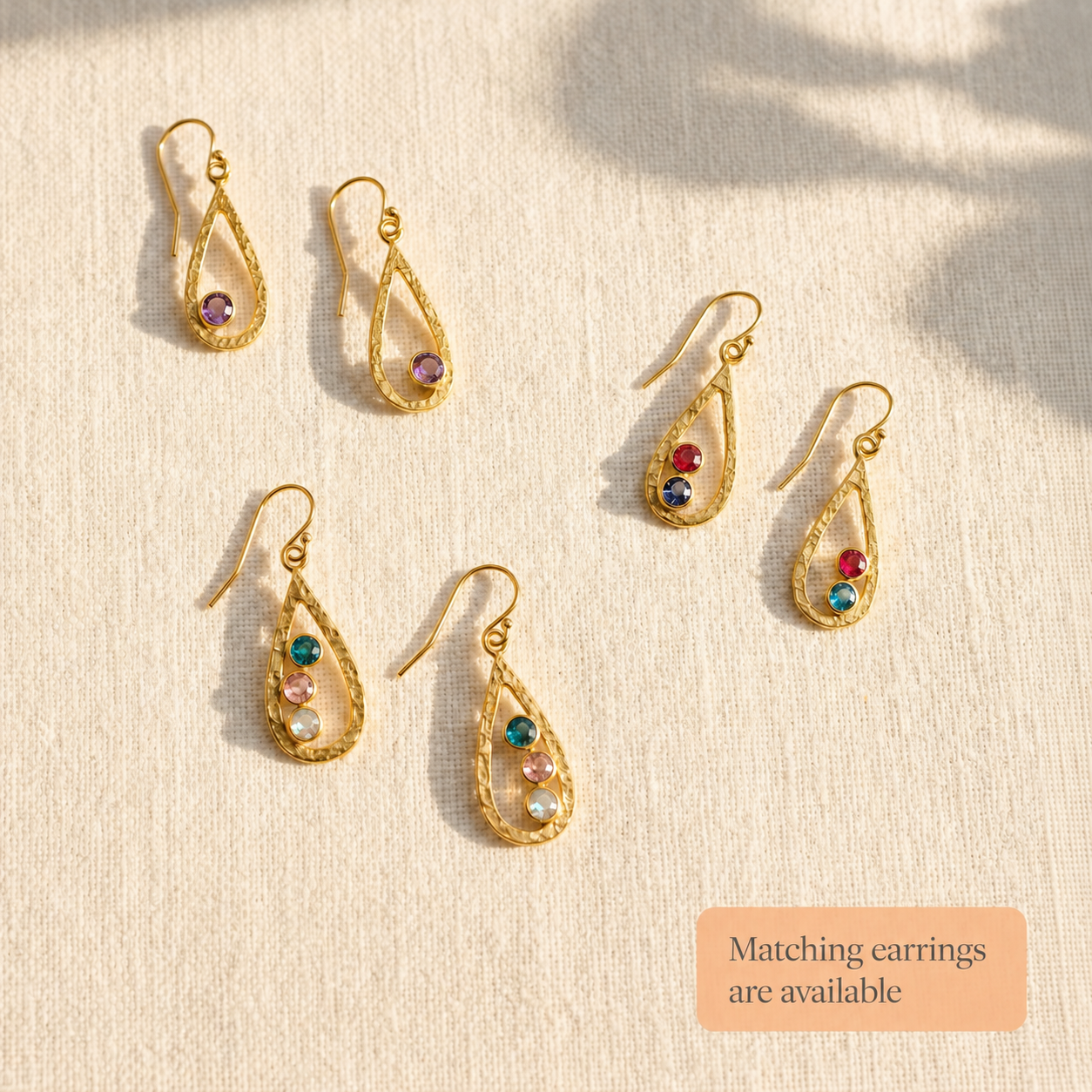 Matching teardrop birthstone earrings with faceted gemstones, available to pair with the custom mom necklace.