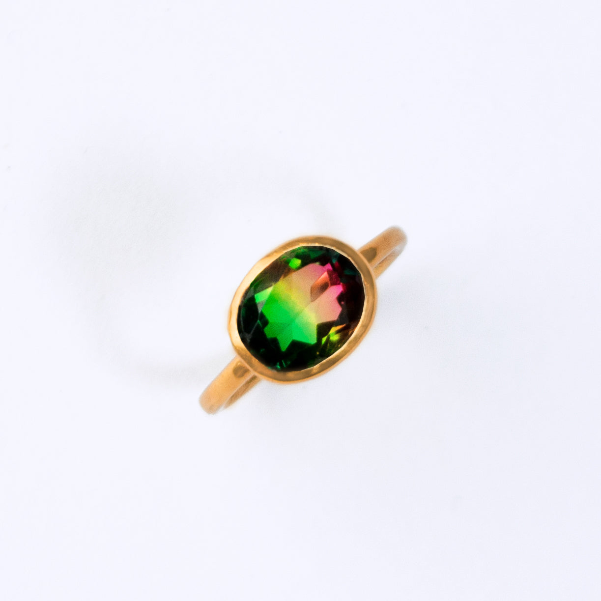 Multicolor gemstone oval ring plated in  rose gold. Green and Pink gemstone with a line of yellow in the center. 8 x 10 mm large oval ring in rose gold.