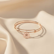 Engraved paw print bracelet displayed on satin, featuring custom pet name on a 16mm disc charm with adjustable bangle design. This personalized pet bracelet is ideal for dog moms, cat moms, and pet lovers looking for a meaningful keepsake or memorial jewelry piece. Crafted in sterling silver, yellow gold, or rose gold for a polished minimalist look. Perfect for birthdays, Mother’s Day, Christmas gifts, or honoring a beloved furry companion.