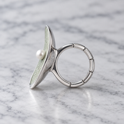 Side profile of Pearl Petal adjustable ring showing segmented flexible band
