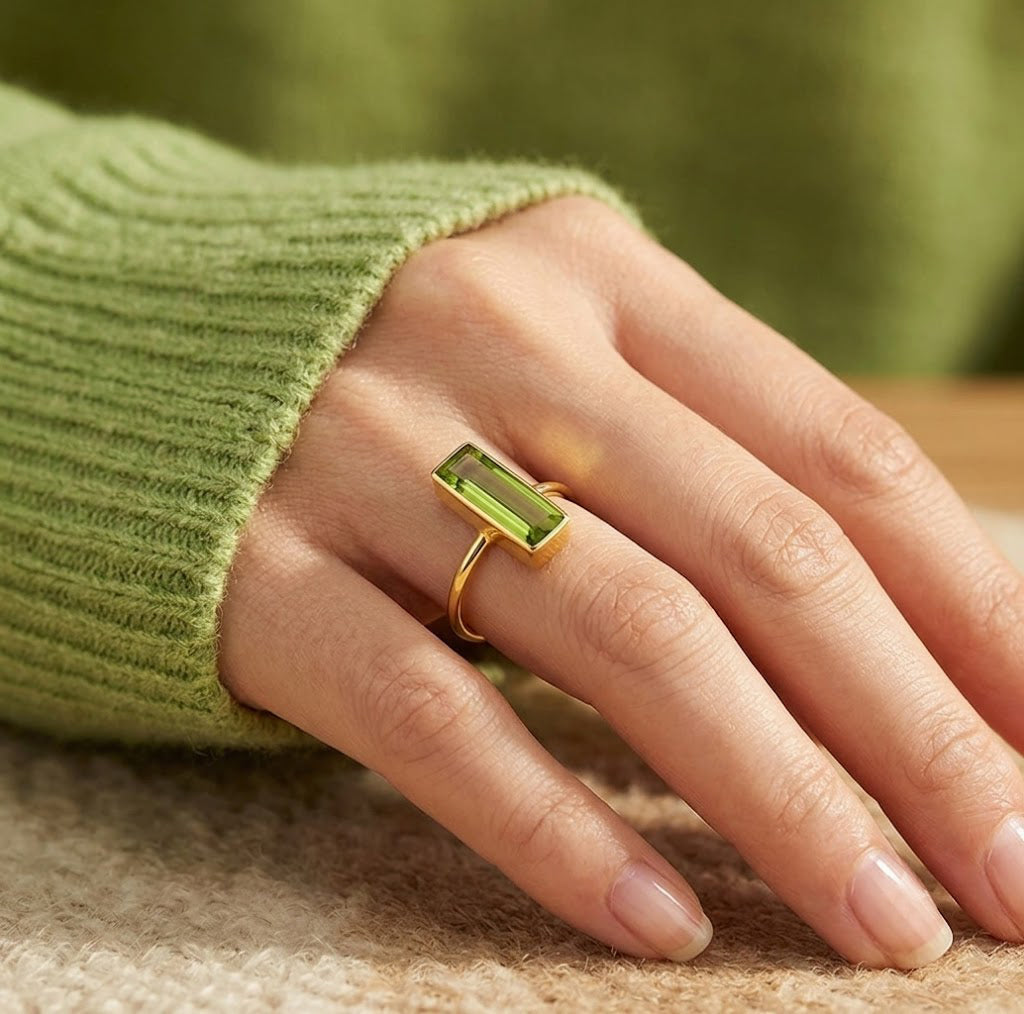 Model wearing a petite vertical Peridot Quartz ring with a soft green sleeve