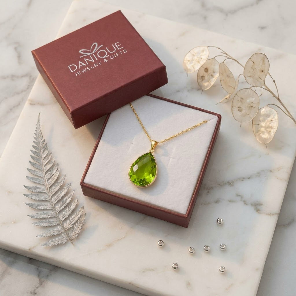 Peridot necklace displayed in a Danique Jewelry branded gift box with soft natural styling.