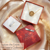 Jewelry box with necklaces and pendants on a soft fabric background, featuring the Danique Jewelry & Gifts brand.