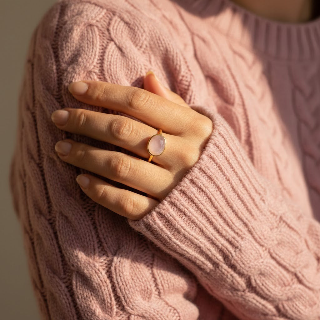 Pink chalcedony oval ring worn on hand with knit sweater, delicate gold gemstone ring for women, feminine minimalist stacking jewelry for everyday elegance