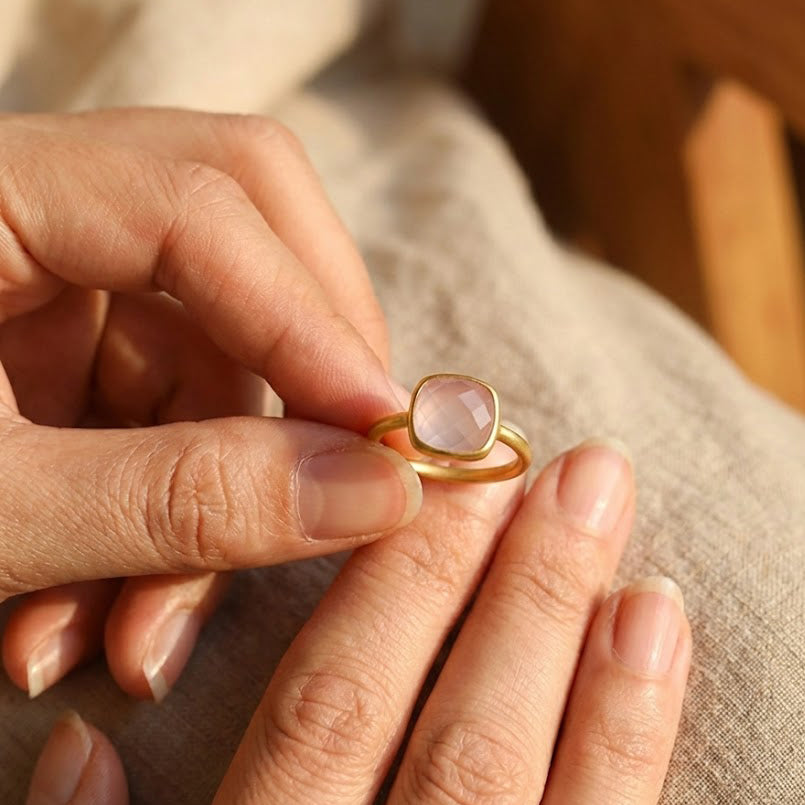 Blush pink chalcedony ring on finger, faceted cushion cut October birthstone ring, dainty feminine gold gemstone jewelry