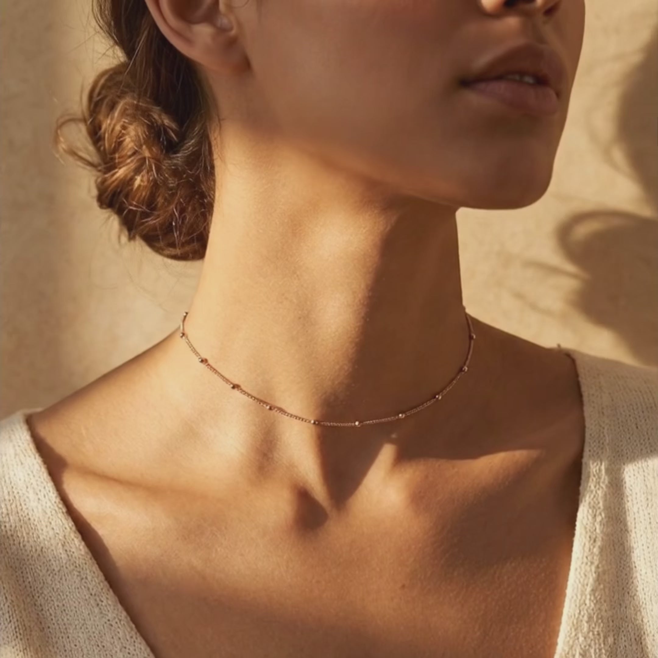 Product video showcasing delicate satellite chain choker necklace, minimalist gold layering necklace for women, dainty everyday jewelry with modern lightweight design