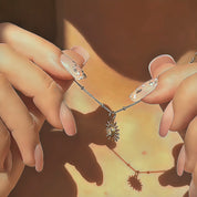 Several custom sunburst birthstone necklaces shown in hand under soft golden light, capturing the shimmer of the satellite chain and the vibrant sparkle of each gemstone. Personalized birthstone jewelry available in gold, silver, and rose gold, a thoughtful birthday, Mother’s Day, Christmas or bridesmaid gift. Modern dainty necklace ideal for layering and everyday wear, with all birthstones offered.