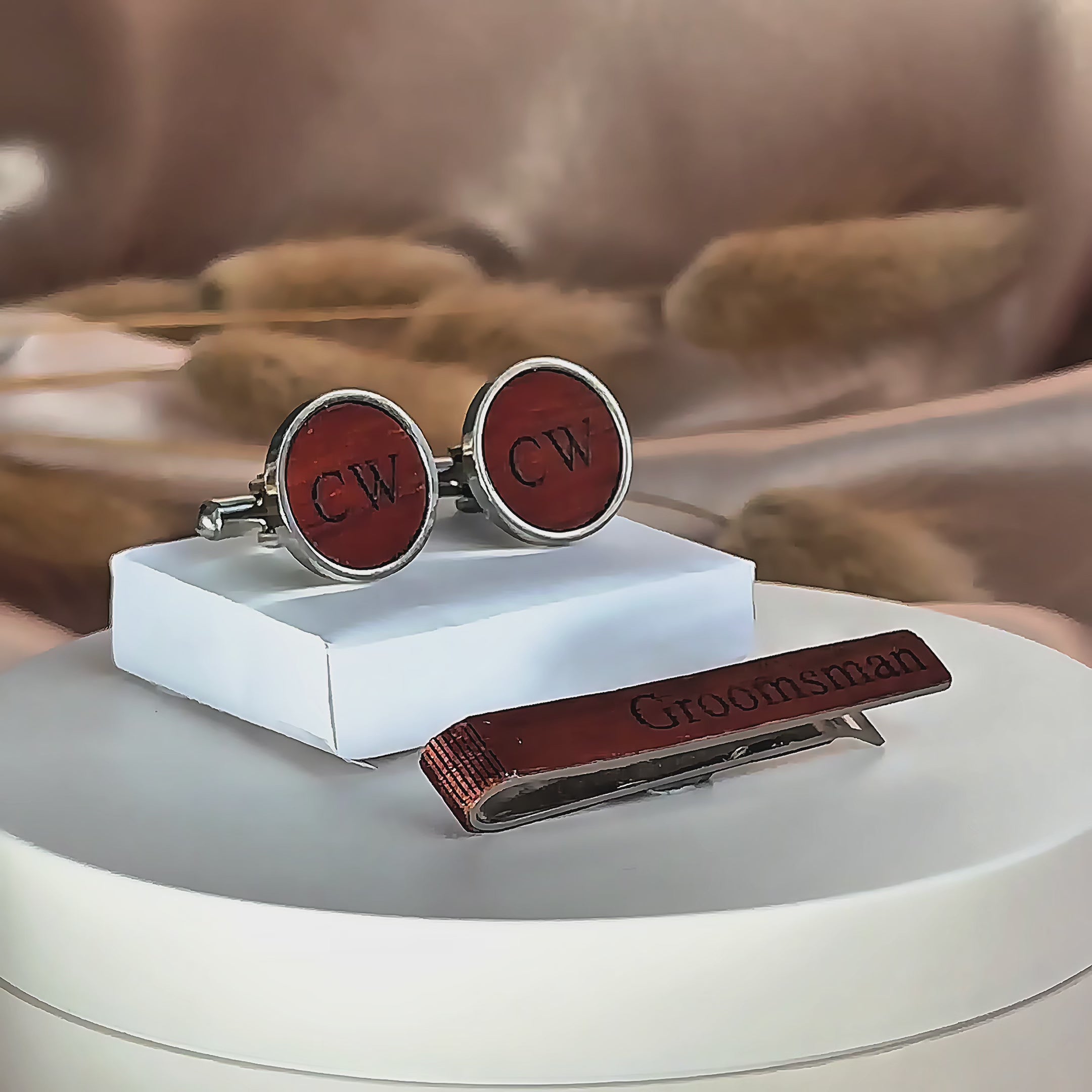 A pan over shows a variety of custom engraved rustic wooden tie clips and cuff links. A birch tie bar is turned front to back to show engravings on both sides. engraving options are monograms, photographs, names, initials, messages, and dates.  Matching cufflinks available. 6 wood finishes to choose from. Perfect for outdoor weddings.