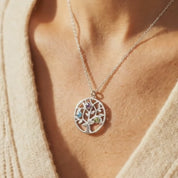 Close up of custom birthstone mom necklace on model, family tree necklace with colorful birthstones, personalized tree of life pendant for mom, elegant everyday birthstone necklace, meaningful mother jewelry gift, minimalist family necklace for women, personalized birthstone pendant in sterling silver, yellow gold, or rose gold, Mother’s Day jewelry, custom family keepsake necklace, gift for mom with children’s birthstones