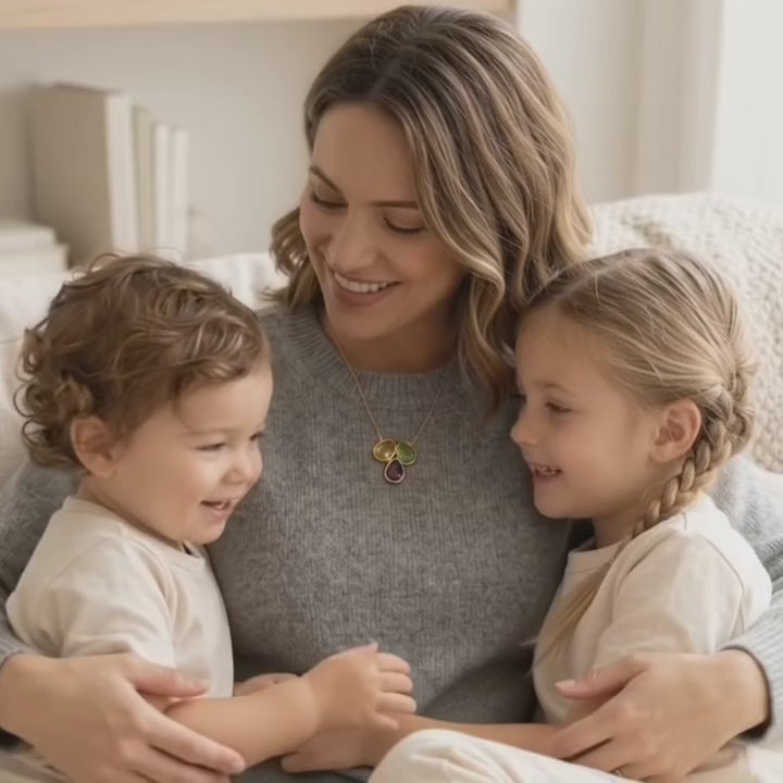 A video showcasing a Custom three birthstone necklace with aqua, pink, and moonstone teardrop gemstones on a delicate gold chain, personalized family jewelry for mom.
