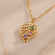 A video showcasing Custom leaf birthstone necklace with up to four colorful stones on a gold chain, personalized family jewelry for mom or grandma.