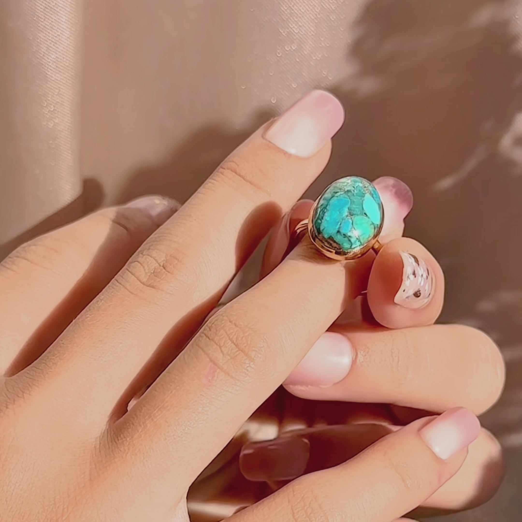 Video: bold oval gemstone statement rings in 14k gold vermeil, bezel-set and highly faceted—mix of emerald-green, ruby, aqua blue and labradorite. Custom birthstone ring, cocktail/stacking style, adjustable sizing options; modern gemstone ring showcase, perfect for anniversary or bridesmaid gifting.