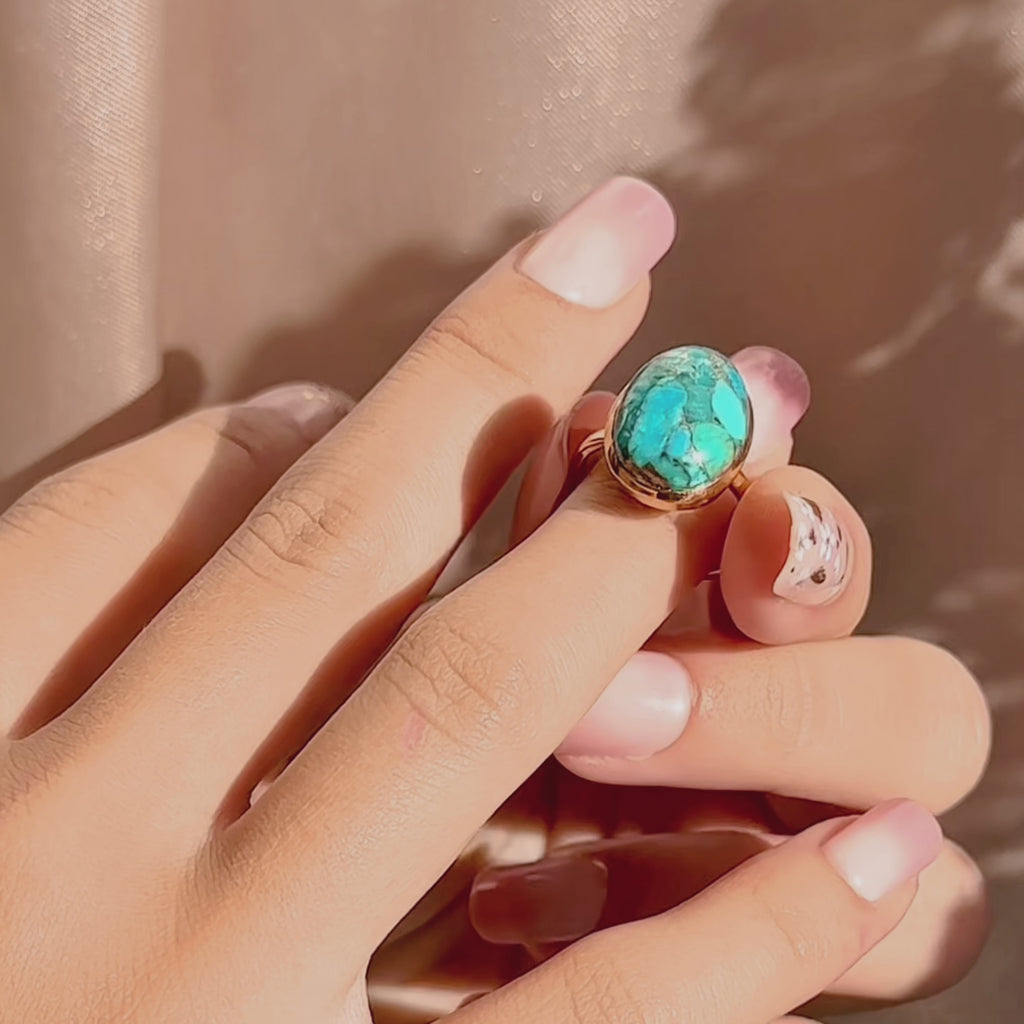 Video: bold oval gemstone statement rings in 14k gold vermeil, bezel-set and highly faceted—mix of emerald-green, ruby, aqua blue and labradorite. Custom birthstone ring, cocktail/stacking style, adjustable sizing options; modern gemstone ring showcase, perfect for anniversary or bridesmaid gifting.