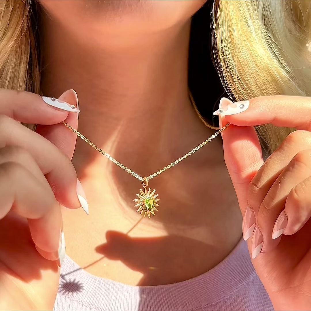 Video showing a sun pendant necklace with a custom birthstone charm on a delicate chain—personalized celestial jewelry that can be customized with any month stone and optional engraving; a minimalist everyday piece and meaningful gift for mom, daughter, or girlfriend.