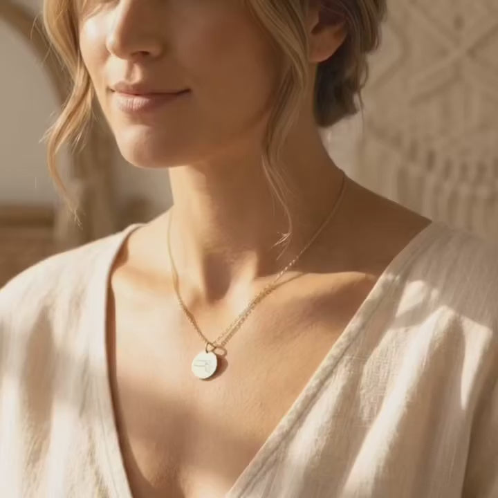 A video showcasing a Personalized state map necklace with heart marking hometown in yellow gold