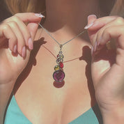 Video of custom birthstone grandma necklace being worn, showing a feminine neckline and hands holding a sterling silver chain with cascading multi-color birthstone charms and leaf accents, personalized family jewelry for mom or grandma, perfect Mother’s Day or birthday gift.