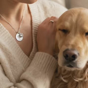 A video showing an engraved paw print necklace with a birthstone. Personalized birthstone jewelry for pet lover, pet portrait gift, custom paw print memorial gift, sentimental gift for pet loss, pet lover, christmas gift for pet lover, birthday gift for pet parent, mother's day gift for pet mom