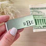 Video featuring a custom engraved metal money clip handcrafted from high-quality stainless steel in gold, silver or black finishes. Personalized with initials, names, monogram, dates, or coordinates, this sleek men’s accessory makes a thoughtful gift for groomsmen, dad, husband, or anniversary.