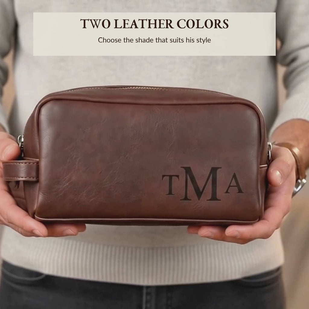 Video showcasing a personalized men’s leather cosmetic bag, or Dopp kit, in rich brown tones, featuring custom compass-style engraving on the side; durable travel toiletry bag and groom’s gift, perfect as a custom engraved Father’s Day, anniversary or groomsmen gift for him.