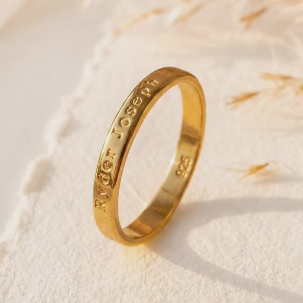 a video showcasing Personalized 3mm engraved ring in yellow gold vermeil with custom outside engraving on a soft neutral background.
